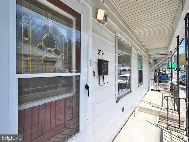 view of exterior entry with a porch