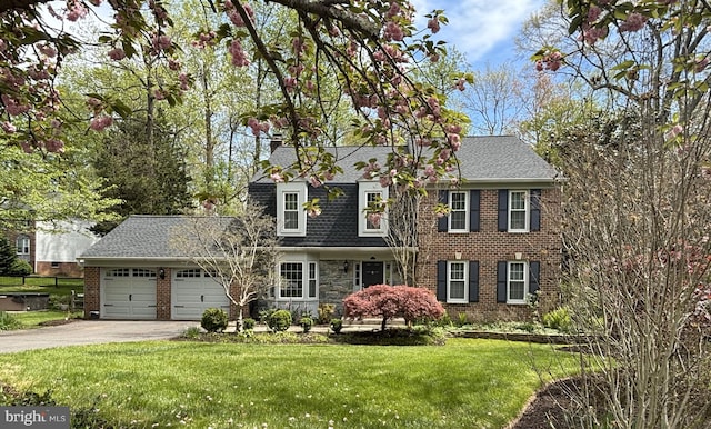7185 Rivers Edge Rd, Columbia, MD 21044 - view of front of house featuring roof with shingles, driveway, brick siding, a front yard, and a garage