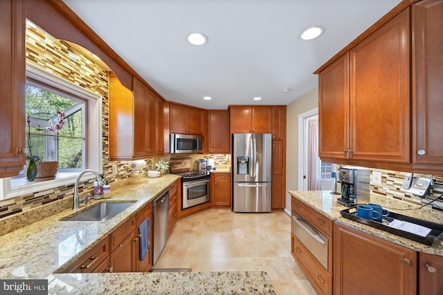 7185 Rivers Edge Rd, Columbia, MD 21044 - kitchen featuring light stone counters, a sink, decorative backsplash, a warming drawer, and stainless steel appliances