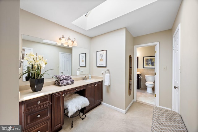 7185 Rivers Edge Rd, Columbia, MD 21044 - full bathroom featuring a skylight, baseboards, vanity, and toilet