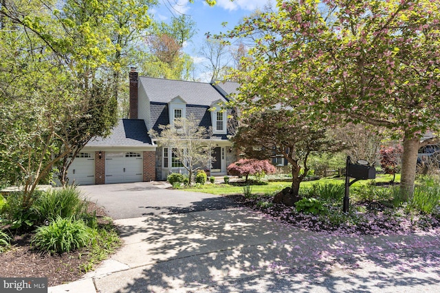 7185 Rivers Edge Rd, Columbia, MD 21044 - view of front of home featuring a chimney, driveway, a shingled roof, an attached garage, and brick siding