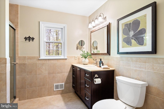 7185 Rivers Edge Rd, Columbia, MD 21044 - full bathroom with an enclosed shower, visible vents, toilet, vanity, and tile walls