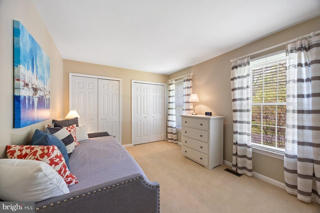 7185 Rivers Edge Rd, Columbia, MD 21044 - bedroom featuring light carpet, multiple windows, multiple closets, and visible vents
