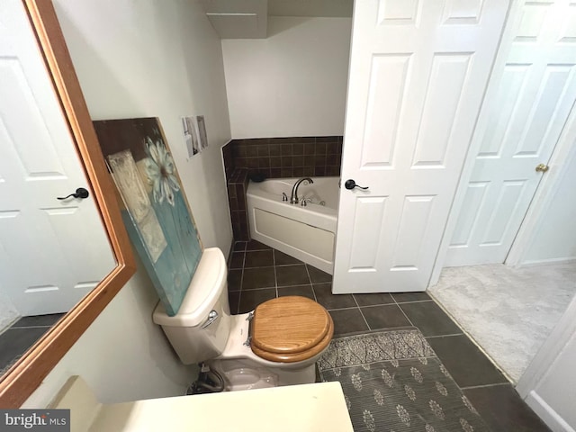 bathroom with a bath, toilet, and tile patterned flooring