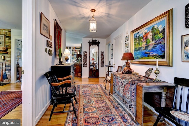 hall with light wood finished floors and baseboards