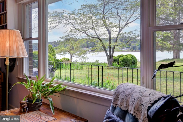 sunroom / solarium with a water view