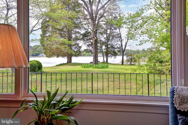 view of yard with a balcony and a water view