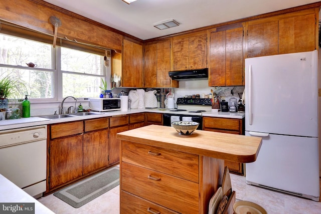 kitchen with a sink, visible vents, butcher block countertops, white appliances, and under cabinet range hood