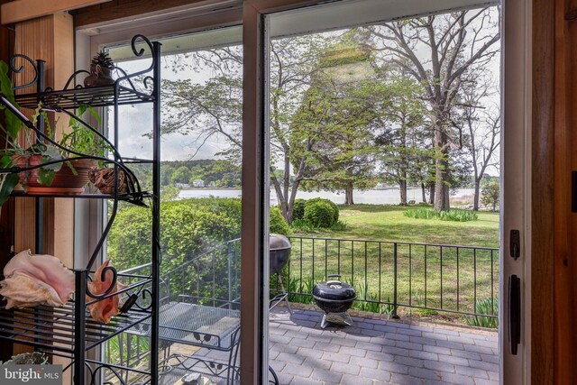 doorway to outside featuring a water view