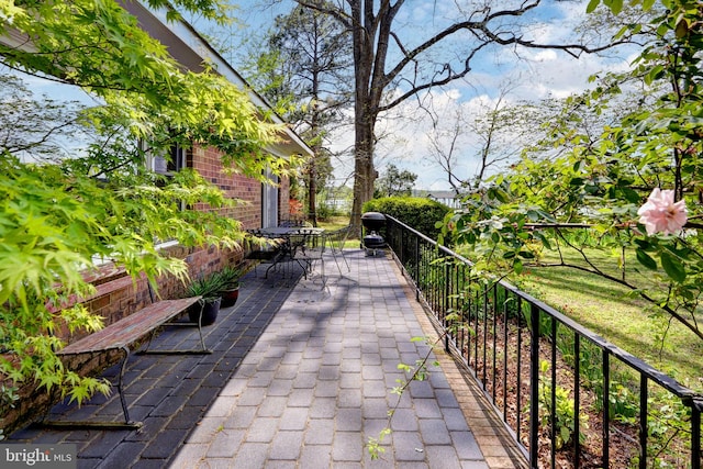 view of community featuring outdoor dining space and a patio area