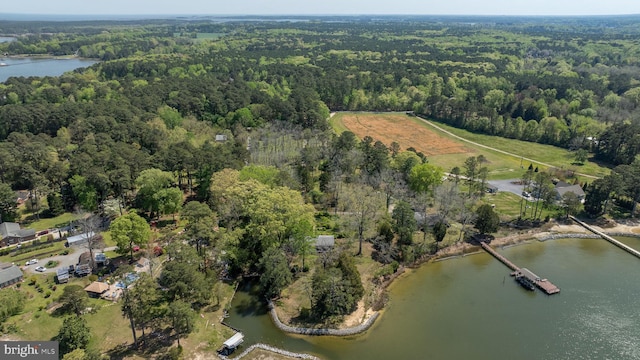 aerial view with a water view and a wooded view
