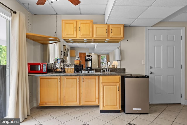 30602 Sandy Landing Rd, Dagsboro, DE 19939 - kitchen featuring a paneled ceiling, dark countertops, a sink, light tile patterned flooring, and a wealth of natural light