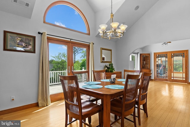30602 Sandy Landing Rd, Dagsboro, DE 19939 - dining area featuring french doors, arched walkways, visible vents, and light wood-type flooring