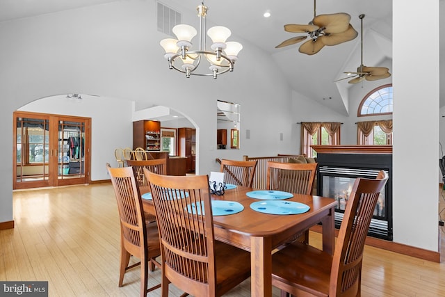 30602 Sandy Landing Rd, Dagsboro, DE 19939 - dining room with arched walkways, high vaulted ceiling, baseboards, light wood-type flooring, and visible vents