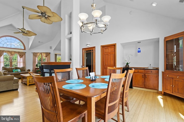 30602 Sandy Landing Rd, Dagsboro, DE 19939 - dining area with high vaulted ceiling, ceiling fan with notable chandelier, and light wood-style flooring