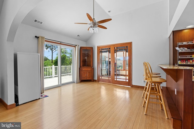30602 Sandy Landing Rd, Dagsboro, DE 19939 - dining room featuring visible vents, a ceiling fan, light wood-type flooring, french doors, and arched walkways