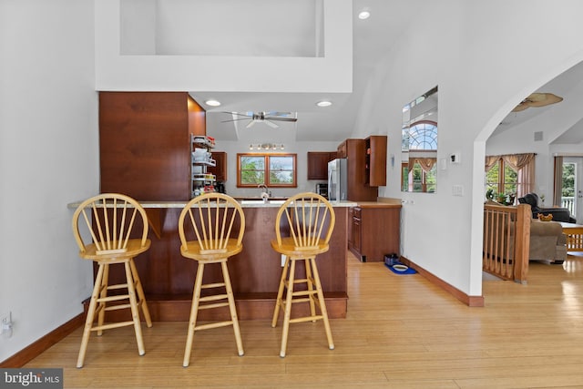 30602 Sandy Landing Rd, Dagsboro, DE 19939 - bar featuring ceiling fan, light wood finished floors, arched walkways, high vaulted ceiling, and baseboards