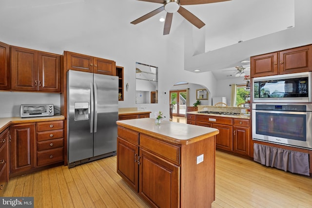 30602 Sandy Landing Rd, Dagsboro, DE 19939 - kitchen featuring a ceiling fan, a center island, light wood-type flooring, light countertops, and stainless steel appliances