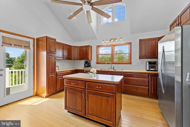 30602 Sandy Landing Rd, Dagsboro, DE 19939 - kitchen with a sink, light countertops, high vaulted ceiling, freestanding refrigerator, and a wealth of natural light