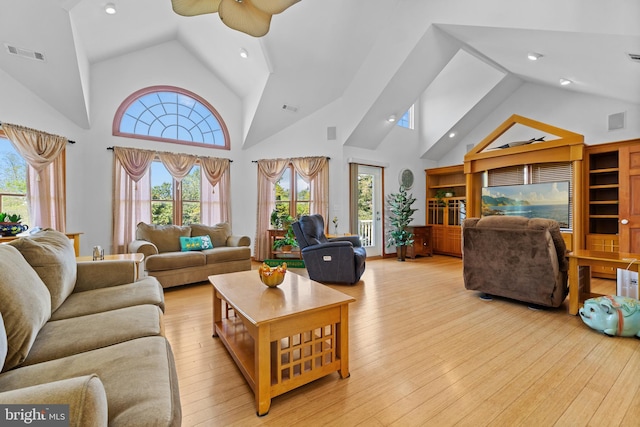 30602 Sandy Landing Rd, Dagsboro, DE 19939 - living area with high vaulted ceiling, visible vents, a healthy amount of sunlight, and light wood-style flooring