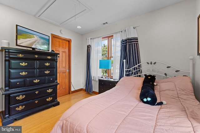 30602 Sandy Landing Rd, Dagsboro, DE 19939 - bedroom featuring visible vents, light wood-style floors, attic access, baseboards, and access to outside