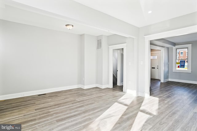 interior space featuring wood finished floors, visible vents, and baseboards