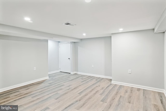 finished below grade area featuring visible vents, recessed lighting, light wood finished floors, and baseboards