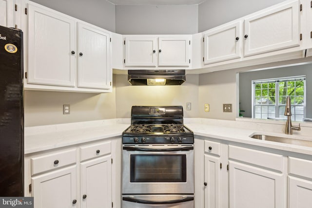 3723 Hampton Ct, Alexandria, VA 22306 - kitchen featuring gas range, under cabinet range hood, white cabinets, and freestanding refrigerator