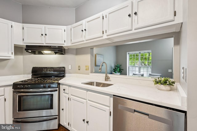 3723 Hampton Ct, Alexandria, VA 22306 - kitchen with under cabinet range hood, appliances with stainless steel finishes, white cabinetry, and light stone countertops