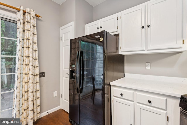 3723 Hampton Ct, Alexandria, VA 22306 - kitchen featuring black fridge, white cabinets, dark wood-type flooring, and light stone counters