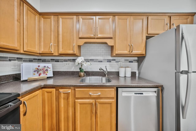 kitchen with backsplash, stainless steel dishwasher, dark countertops, and a sink