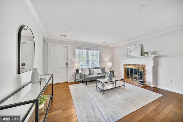 living room with a fireplace, wood finished floors, and ornamental molding