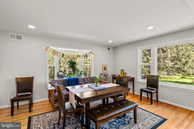 dining area featuring a healthy amount of sunlight, light wood-style floors, and visible vents