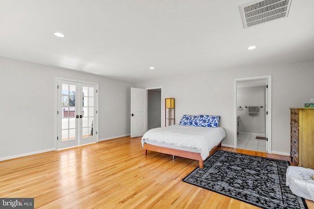 bedroom featuring wood finished floors, visible vents, and recessed lighting