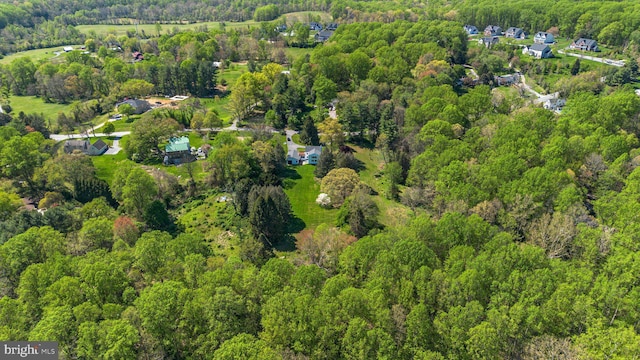 bird's eye view featuring a wooded view