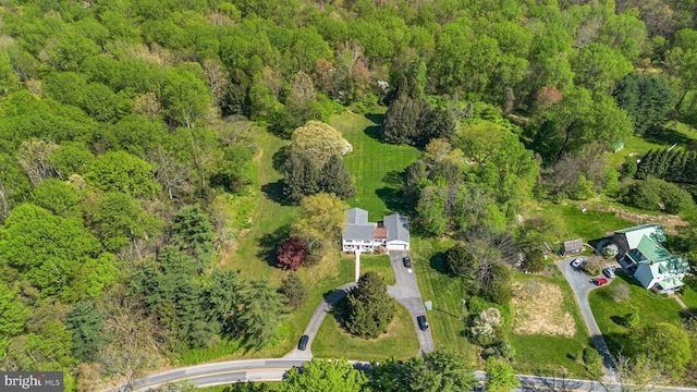 birds eye view of property with a forest view