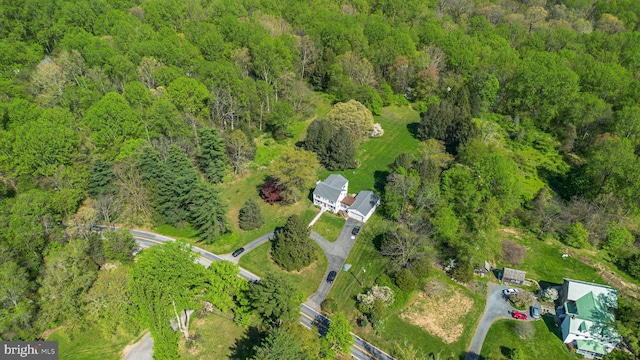 birds eye view of property with a forest view