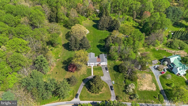 birds eye view of property with a view of trees