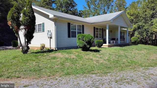 view of front of house with covered porch and a front yard