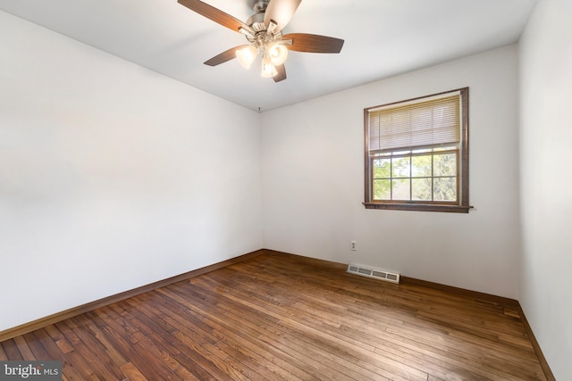 unfurnished room with visible vents, a ceiling fan, baseboards, and wood-type flooring