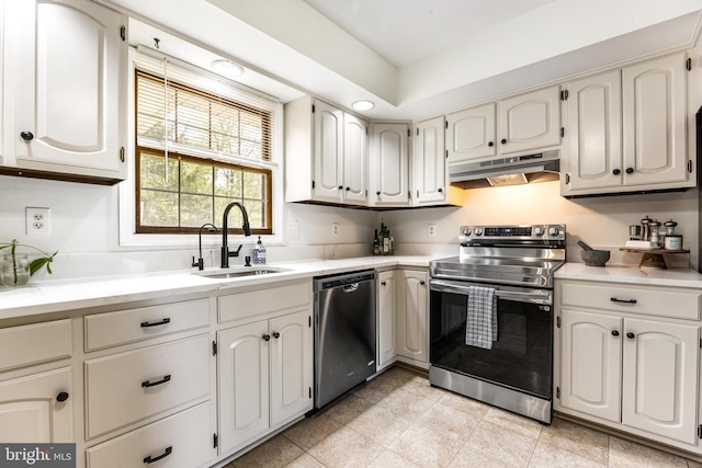kitchen featuring a sink, under cabinet range hood, light tile patterned floors, light countertops, and appliances with stainless steel finishes