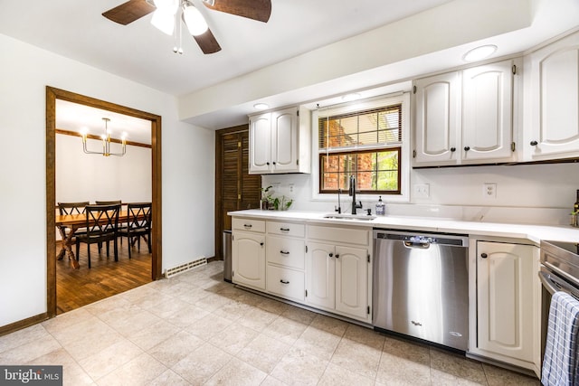 kitchen featuring stainless steel appliances, light countertops, ceiling fan with notable chandelier, a sink, and visible vents