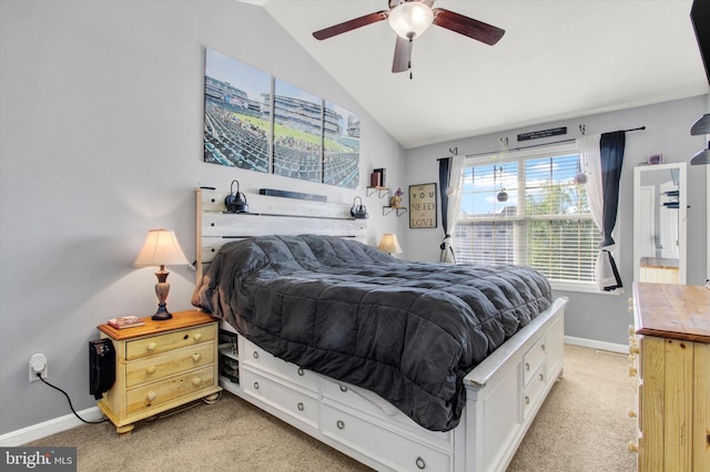 bedroom with light carpet, a ceiling fan, vaulted ceiling, and baseboards