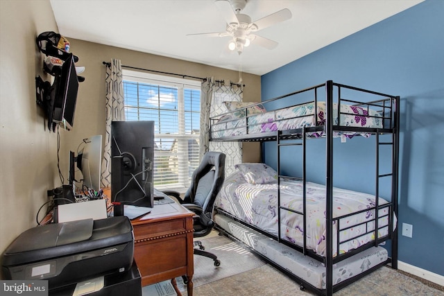 carpeted bedroom featuring baseboards and ceiling fan