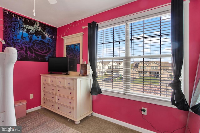 carpeted bedroom with baseboards and multiple windows