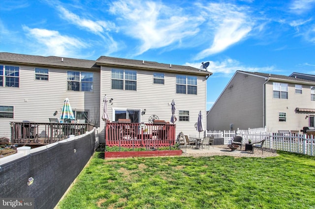 back of property with a lawn, fence, and a patio area