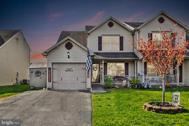 traditional-style house with central AC, driveway, a porch, a lawn, and a garage