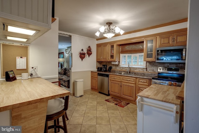 2066 Old York Rd, Burlington, NJ 08016 - kitchen with appliances with stainless steel finishes, butcher block countertops, backsplash, a sink, and a chandelier