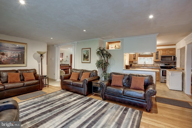 2066 Old York Rd, Burlington, NJ 08016 - living area with ornate columns, light wood-style floors, crown molding, and recessed lighting