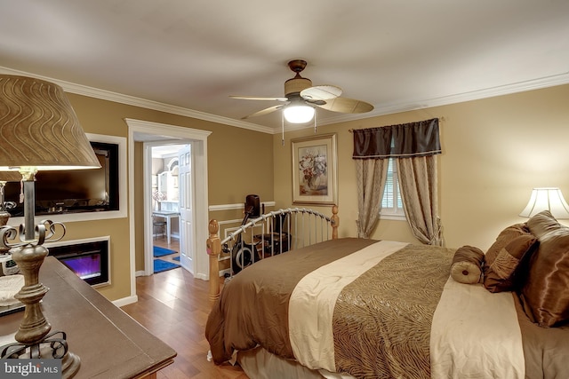 2066 Old York Rd, Burlington, NJ 08016 - bedroom featuring ornamental molding, a glass covered fireplace, wood finished floors, a ceiling fan, and baseboards